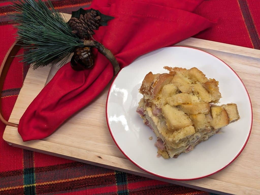 Ham and Cheese Breakfast Strata on a plate with a holiday napkin