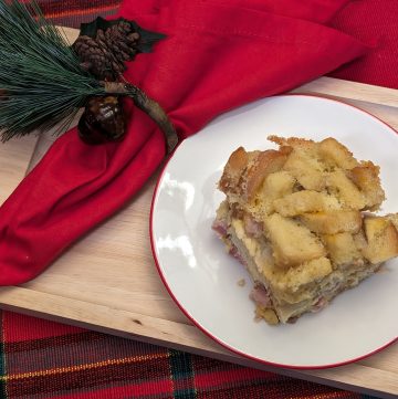 Ham and Cheese Breakfast Strata on a plate with a holiday napkin