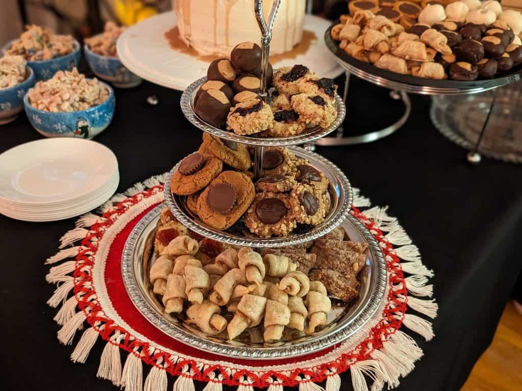 3 Tier Cookie Tray Containing: Butter Horns, Chocolate Cinnamon Log Cookies, Butterballs, Peanut Butter Blossoms, Chocolate Thumbprints, Buckeyes, and Jelly Thumbprints