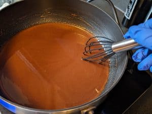 Making Chocolate Salted Caramel Filling in a saucepan on an induction burner