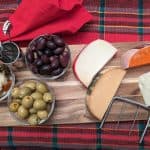 Assorted Cheeses, Olives, and Pickled Vegetables on a Serving Board
