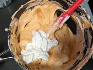 Folding whipped cream into the chipotle sweet cream base for Chipotle Keto Ice Cream