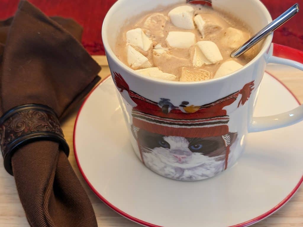 Cat mug filled with keto hot chocolate and marshmallows for the Keeping Warm Dinner Party