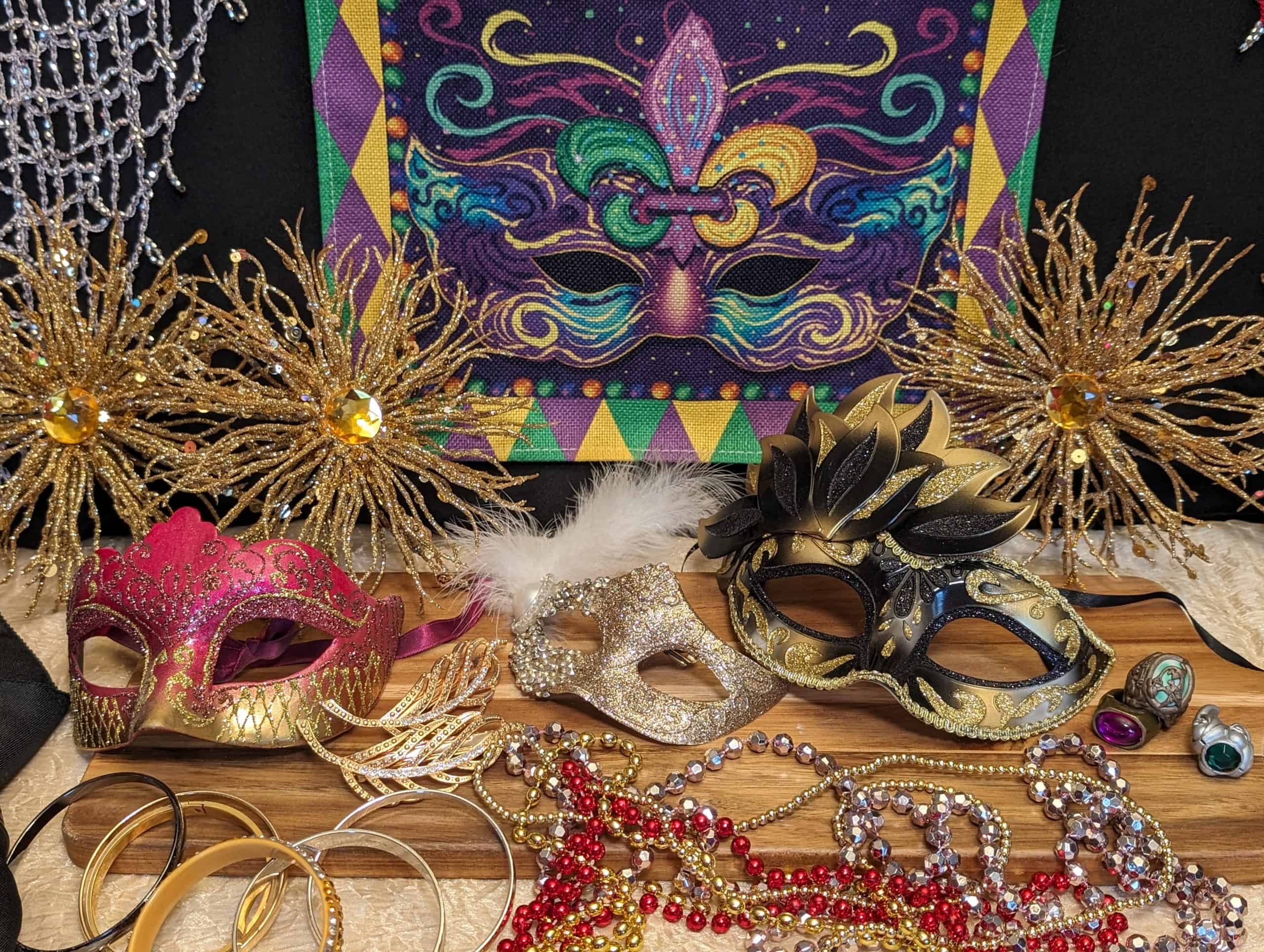 Mardi Gras Dinner Party Display with masks, beaded necklaces, shiny bracelets, and rings