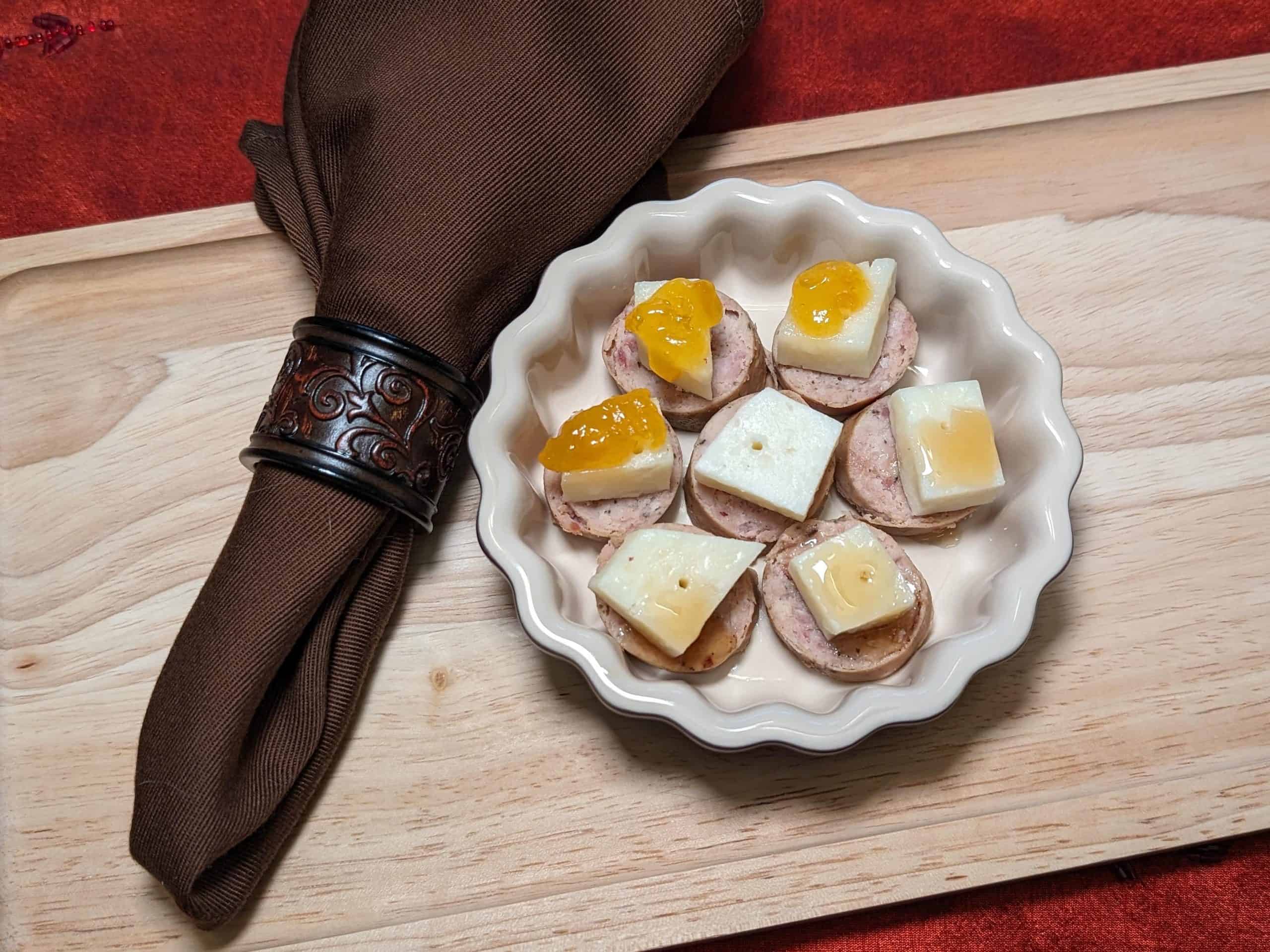 Sausage and Manchego Bites Plated showing 3 versions: no topping, topped with keto honey, topped with sugar free apricot preserves