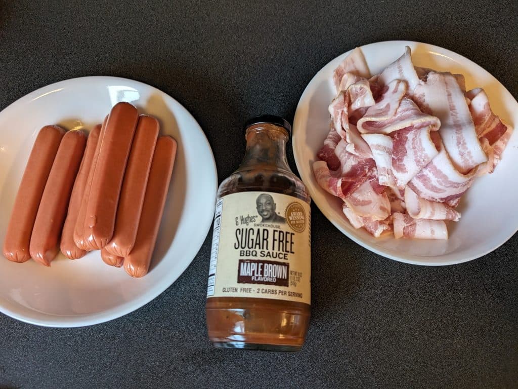 Ingredients for Bacon-Wrapped Low Carb BBQ Hot Dog Bites - hot dogs, sugar free BBQ sauce, and bacon slices