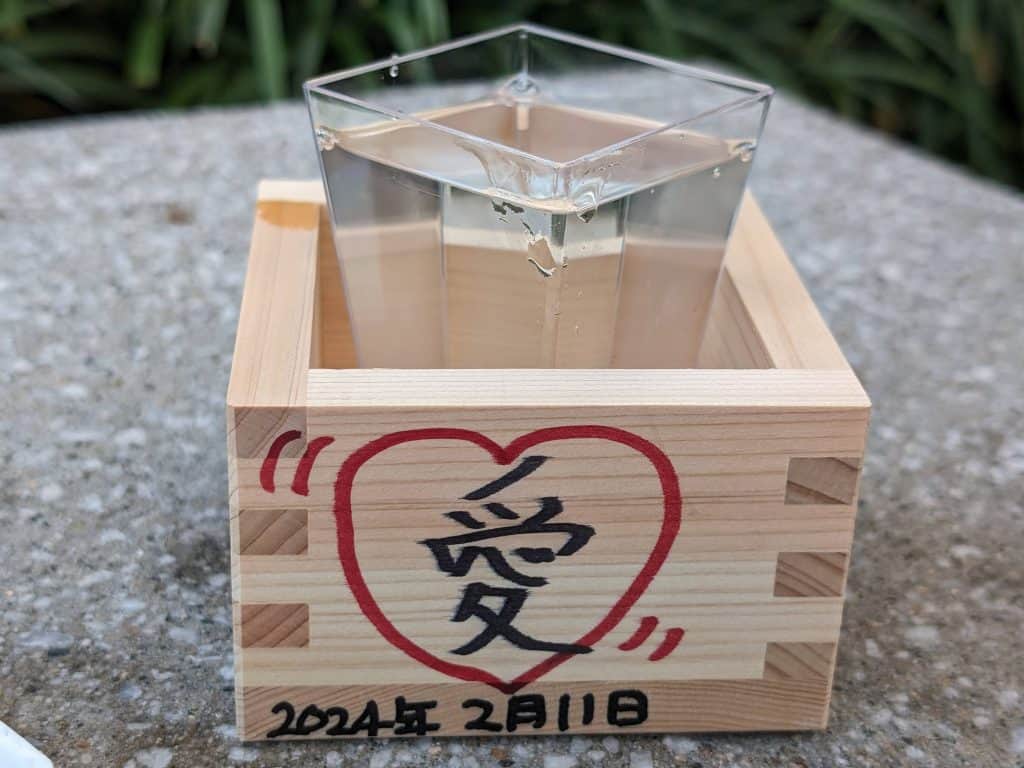 Sake in a plastic cup in a wooden box