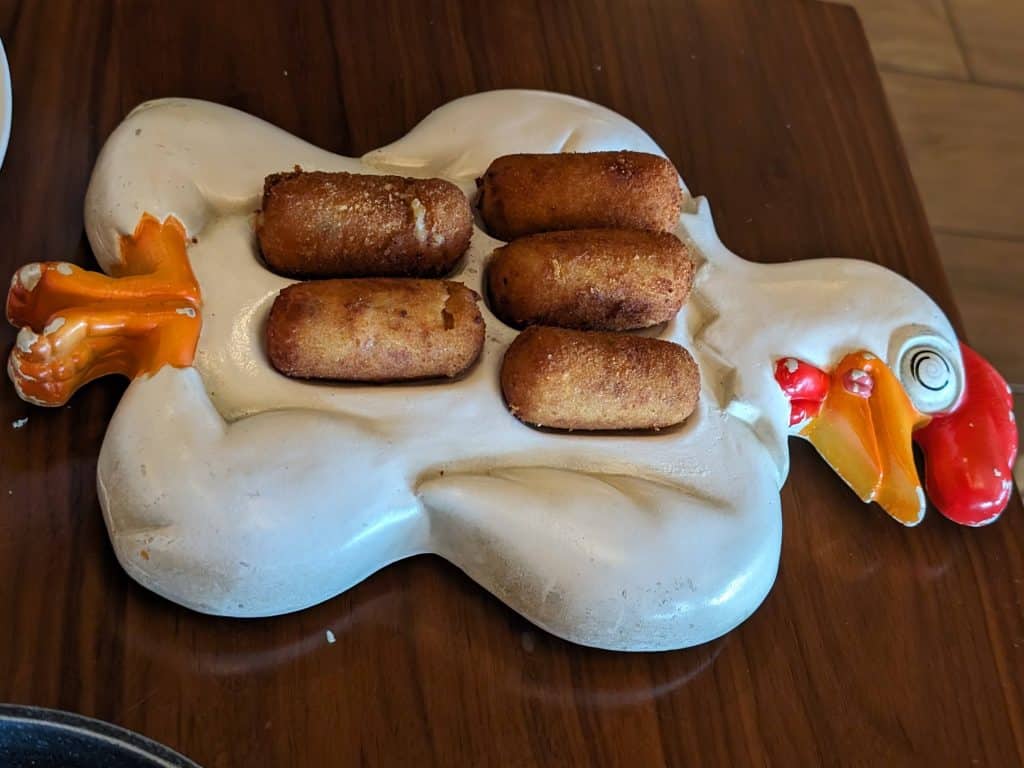 Fried chicken croquettes on a plate shaped like a chicken