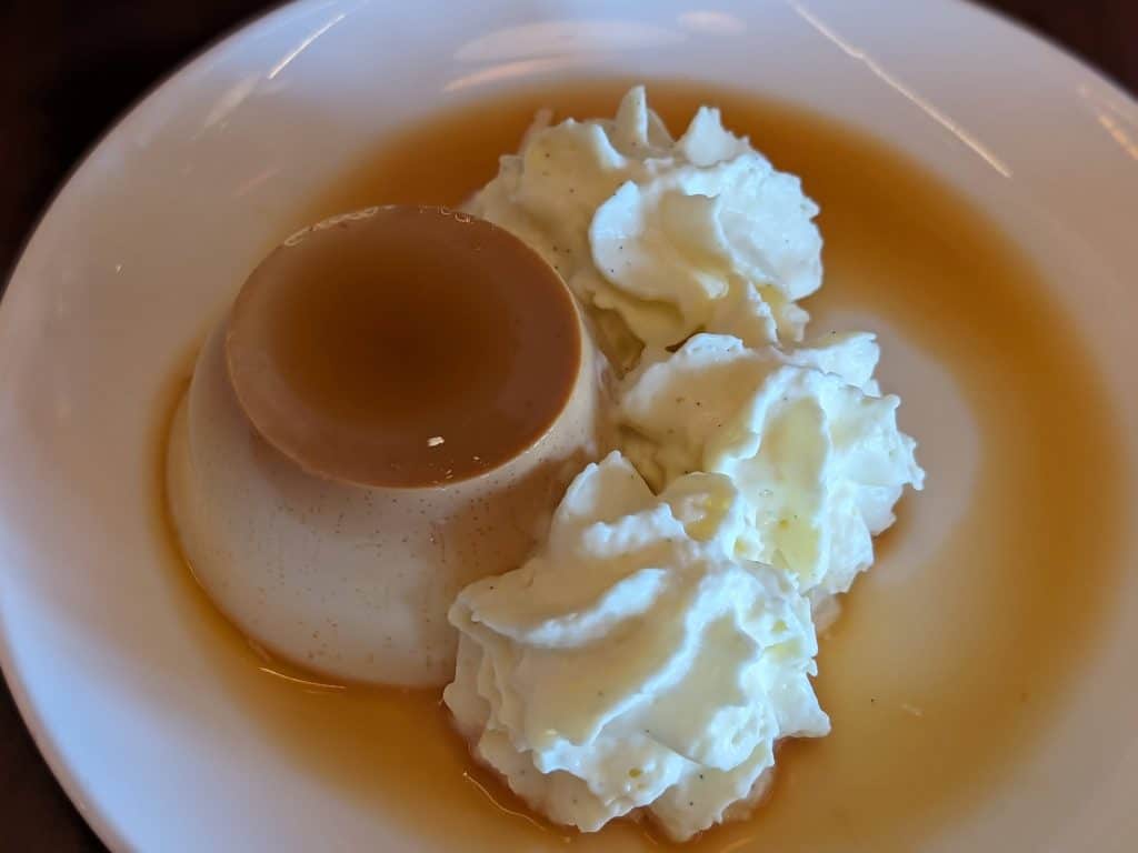 Flan with a caramel sauce and dollops of whipped crema Catalan