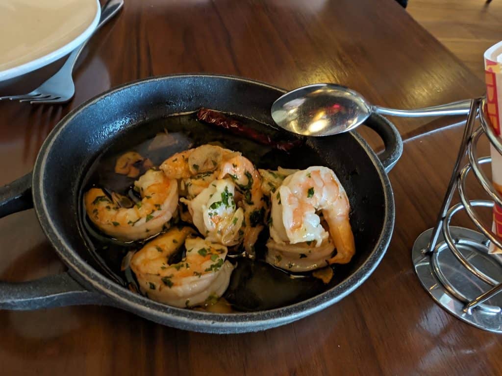 Garlic butter coated shrimp in a cast iron pan