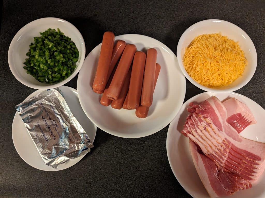 Ingredients for Bacon-Wrapped Stuffed Hot Dogs - hot dogs, diced jalapeños, cream cheese, shredded cheddar, and bacon