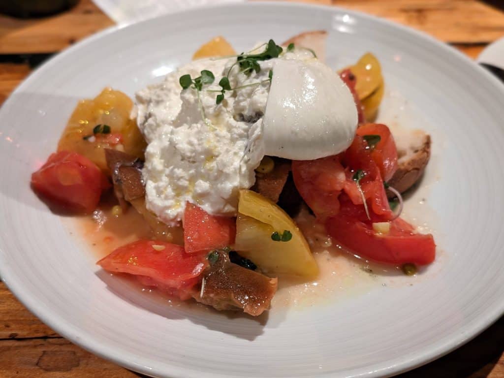 Burrata on top of a tomato salad