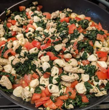 Caprese Chicken Spinach Skillet in a pan