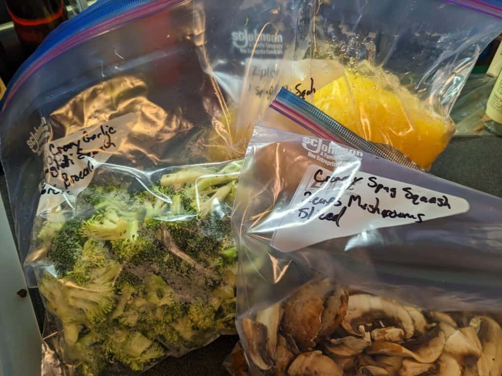 Multiple zip top bags of prepped ingredients labeled with ingredient, quantity, and associated recipe name