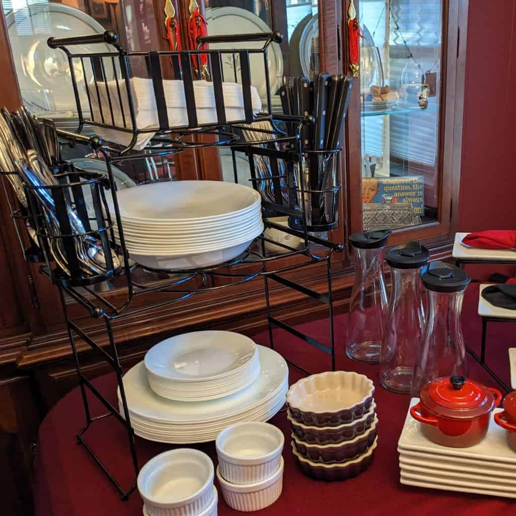 Modular serving caddy with napkins, silverware, and plates on a table