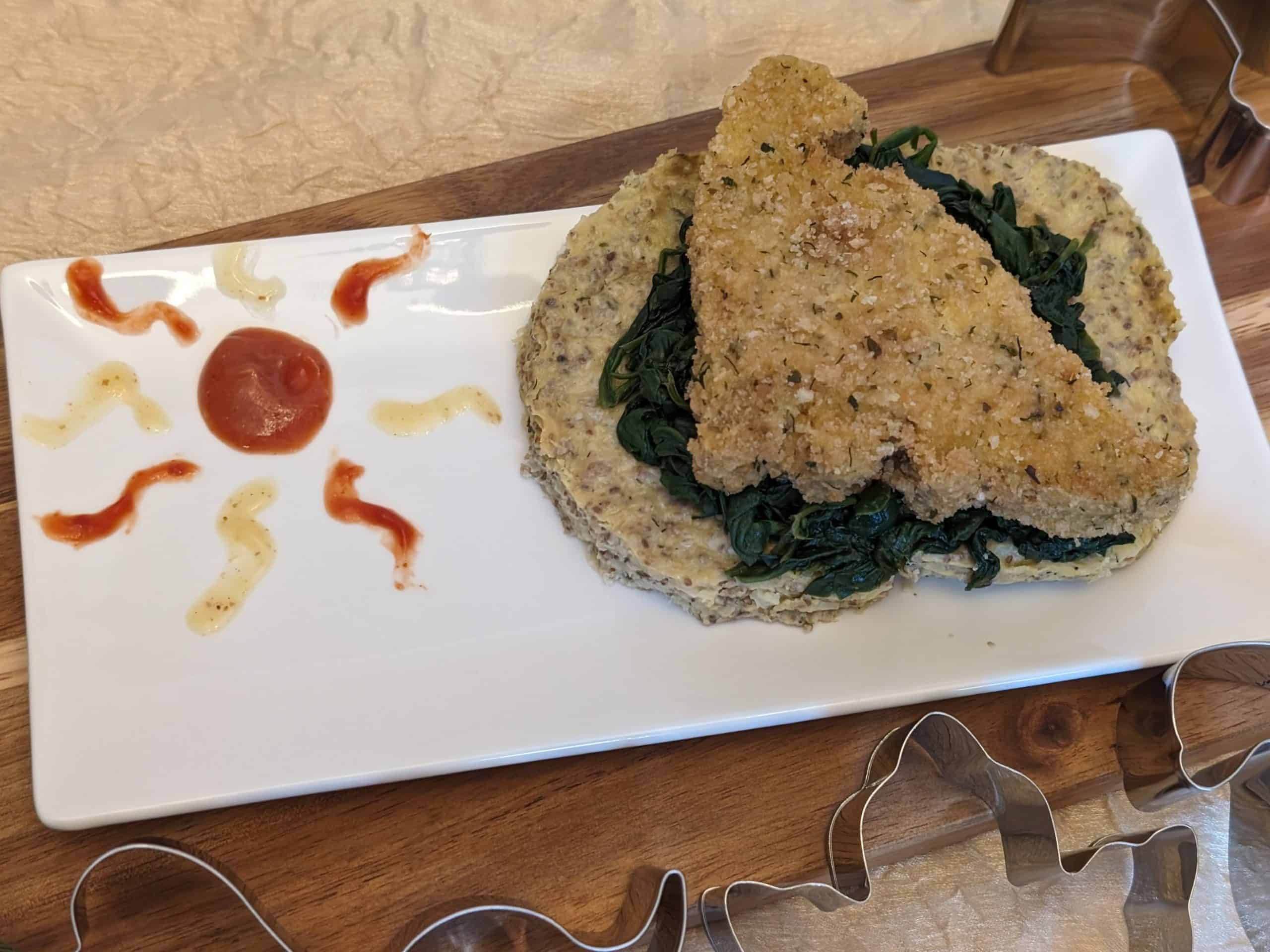 Dinosaur Chicken Patty on a bed of Sautéed Garlicky Spinach and a Ranch Cauliflower Chia Cake for a Dinosaur Themed Dinner Party