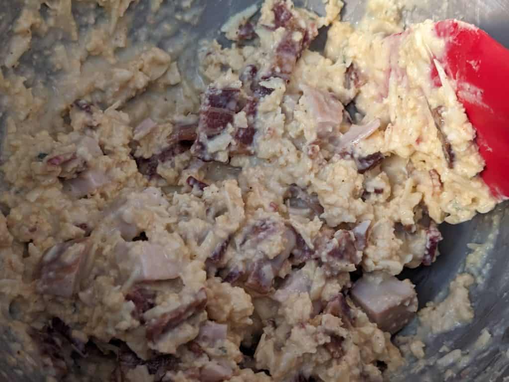 Folding the meat and cheese into the mixture for Keto Kentucky Hot Brown Casserole