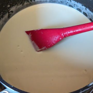 Cooking Keto Mornay Sauce in a saucepan