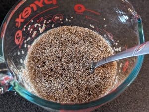 Soaking chia seeds in mixture of chicken broth and heavy cream