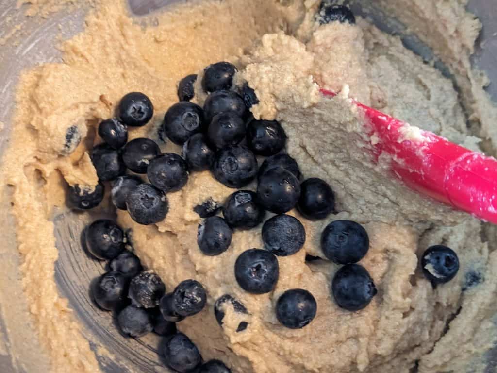 Folding blueberries into the batter for Keto Blueberry Spice Cake