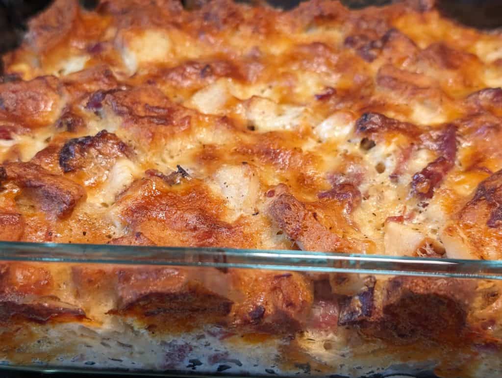 Keto Chicken Ham and Cheese Stuffing - baked and whole in casserole dish side view