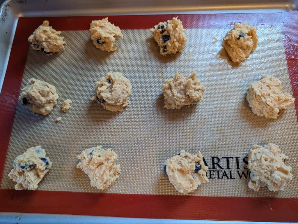 Cookie dough for Keto Blueberry Spice Cookies on a sheet pan ready to bake