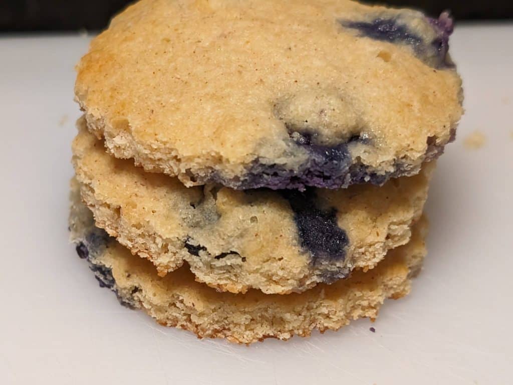 A stack of 3 Keto Blueberry Spice Cookies that have been cut with a cookie cutter
