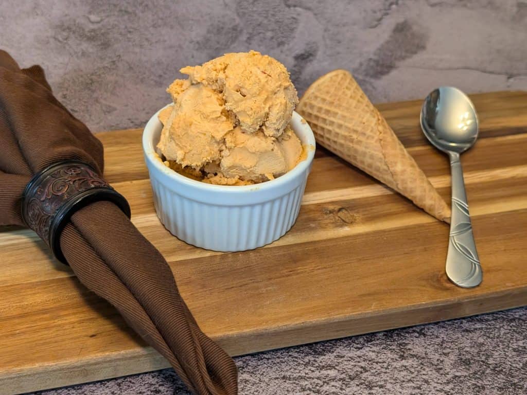 Small ramekin filled with Chipotle Keto Ice Cream with a keto ice cream cone next to it