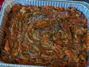 Saucy Zucchini Biscuit Bake in an aluminum half sheet pan ready to bake