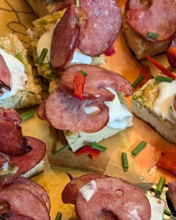 Close up of Mini Frittatas with Smoked Sausage and Creme Fraiche on a serving platter