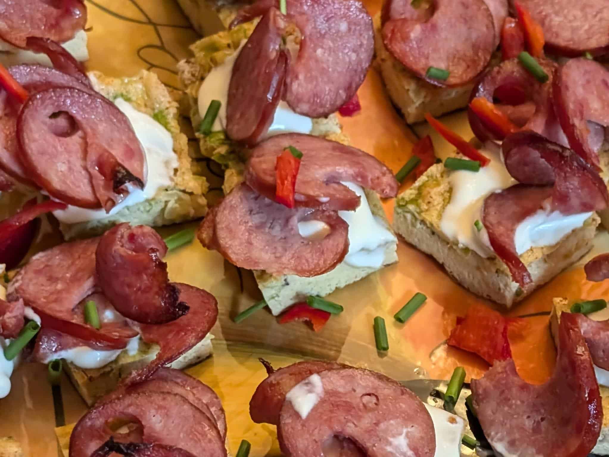 Close up of Mini Frittatas with Smoked Sausage and Creme Fraiche on a serving platter