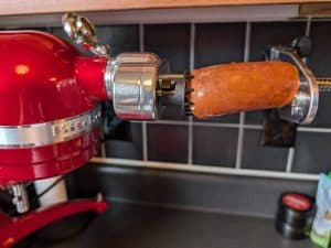 A chunk of smoked sausage skewered on a stand mixer ready to be spiralized