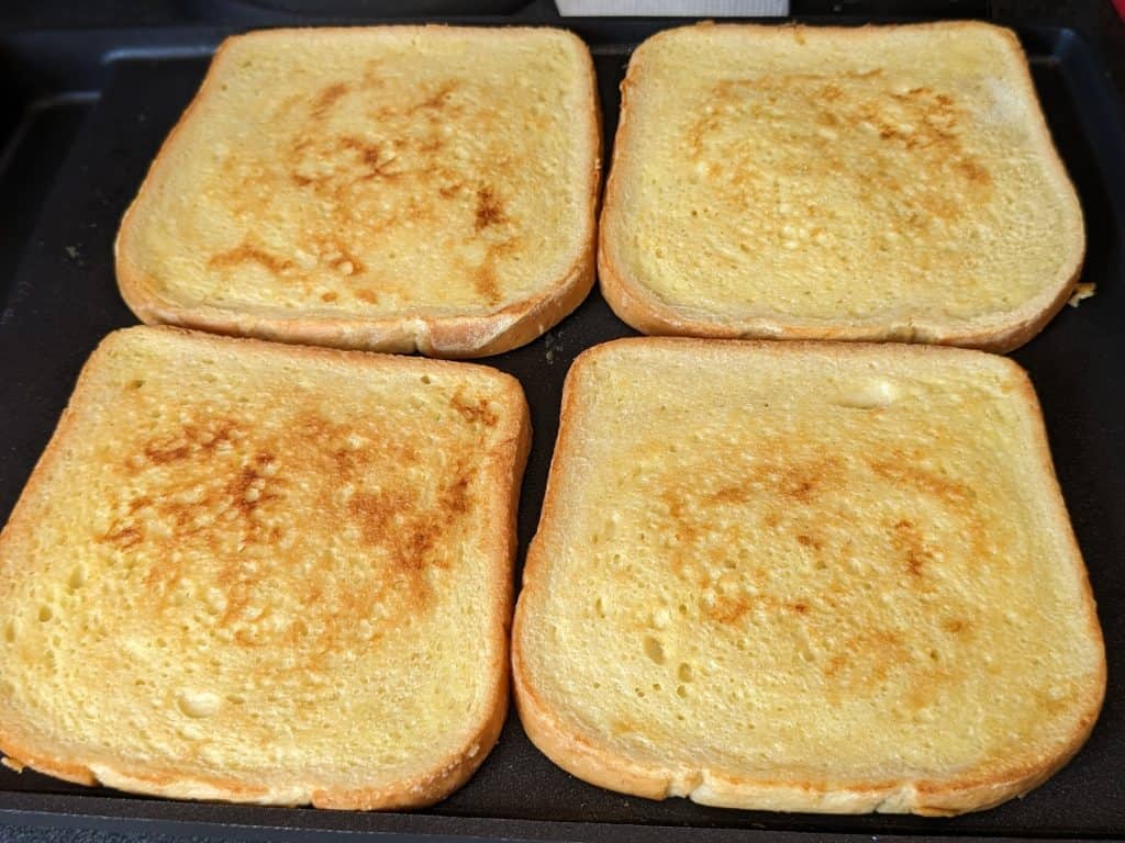 Keto French Toast on the griddle after flipping