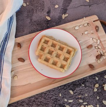 Savory Herbed Waffles plated with some scattered almond slices