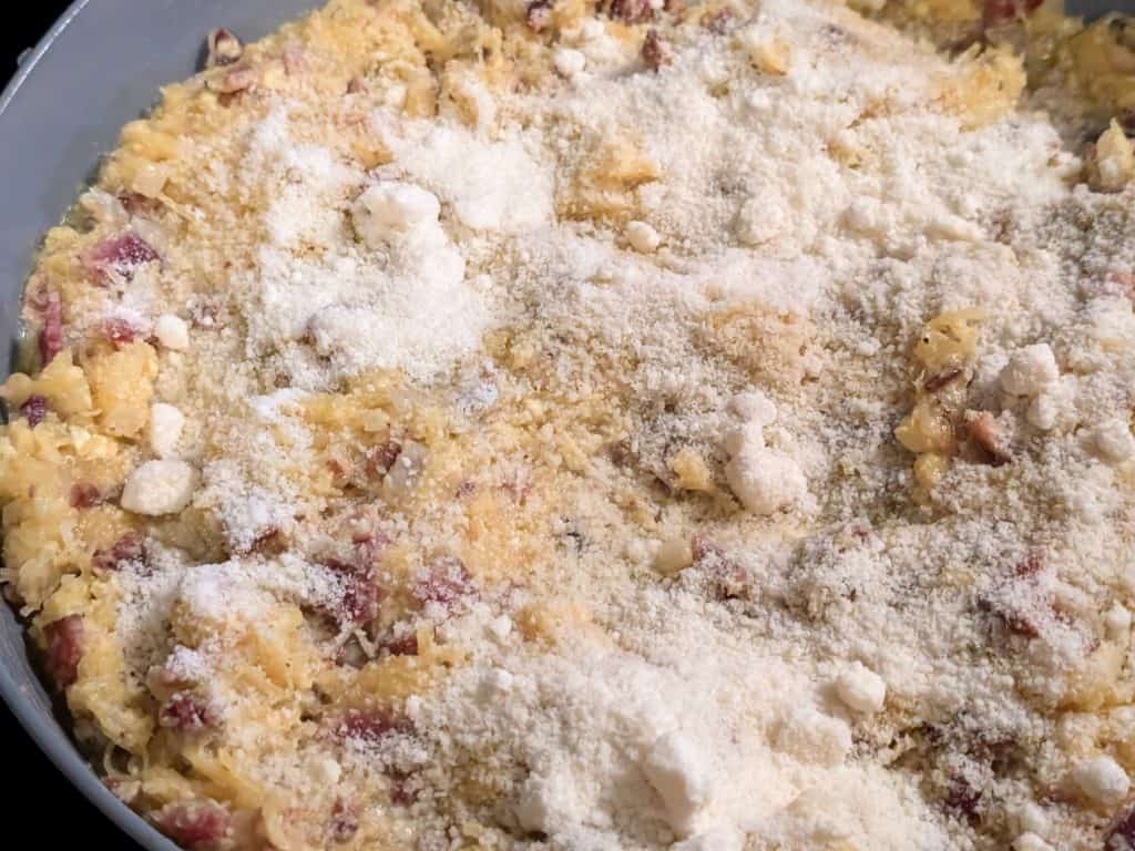 Finished pan of Spaghetti Squash Carbonara topped with grated parmesan cheese