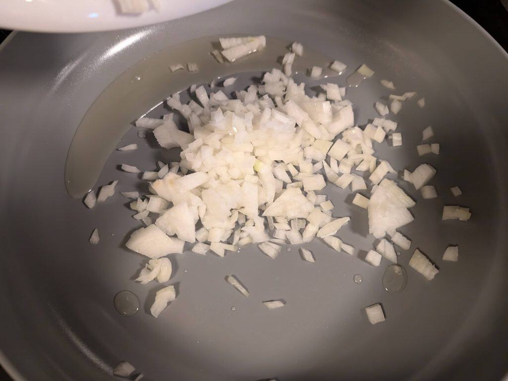 Sauteing chopped onions in a pan