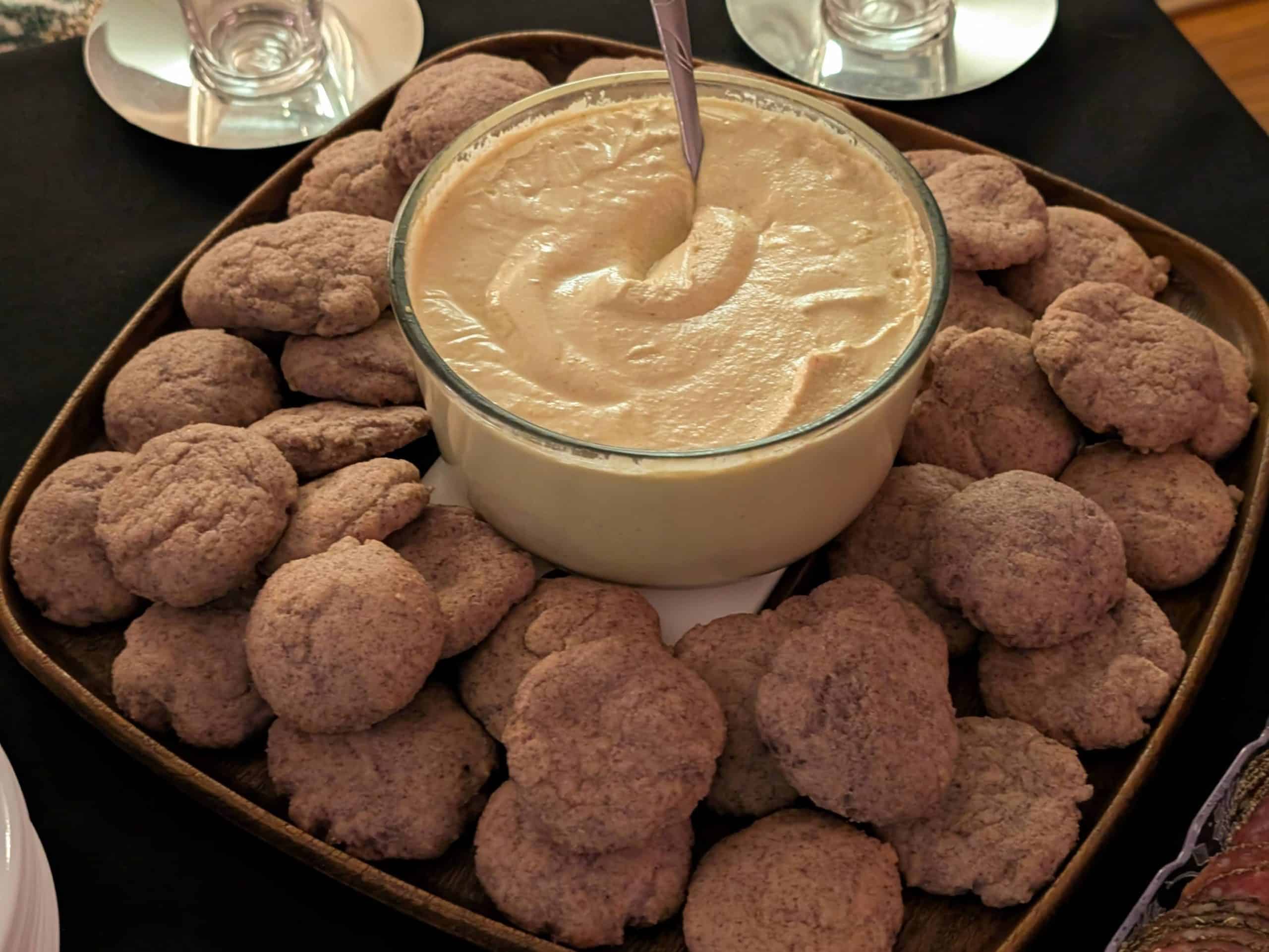 Tangy Curry Cashew Dip in a bowl on a platter of Keto Flatbreads