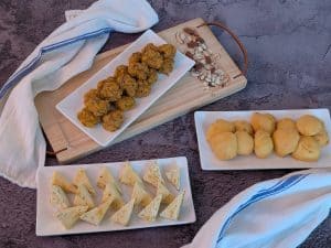 Assorted appetizers made with my Baking Mixes on plates (clockwise from top: Savory Sausage Cheese Balls, Parmesan Puffs, Savory Cheesecake Bites)