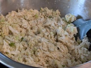 Mixture of crab meat, Dinner Party Diaries Original Baking Mix, minced green onion, and minced celery in a bowl, in preparation for making Keto Crab Cakes