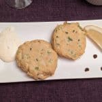 Keto Crab Cakes on a rectangular plate with Lemon-Garlic Aioli, 3 dots of Sriracha, and a wedge of lemon
