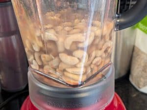 Cashews and soaking liquid in a blender before blending