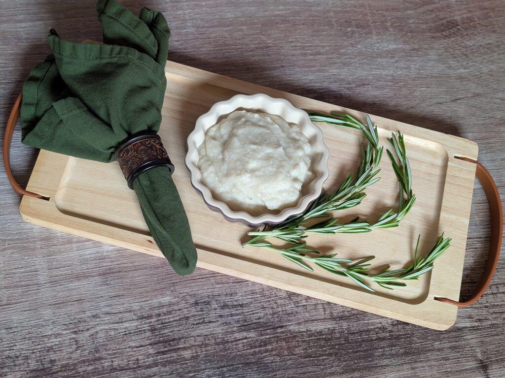 Turnip and Rosemary Purée plated next to sprigs of rosemary