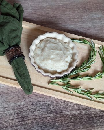 Turnip and Rosemary Purée plated next to sprigs of rosemary