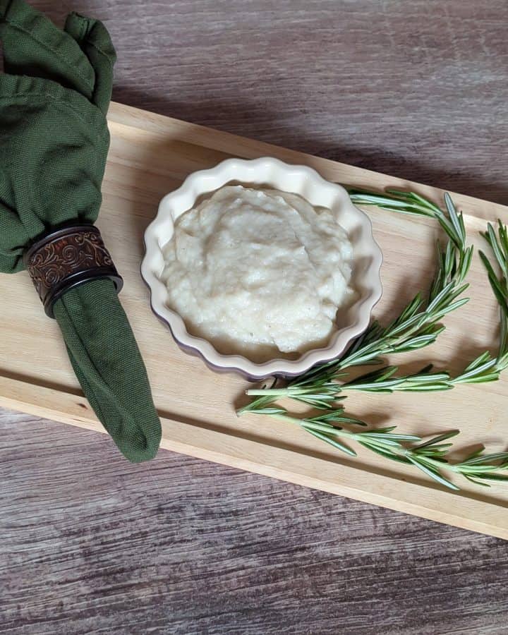Turnip and Rosemary Purée plated next to sprigs of rosemary