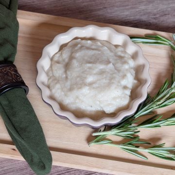 Turnip and Rosemary Purée plated next to sprigs of rosemary close-up