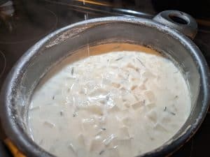 Cubed turnips in a simmering pot of unsweetened almond milk