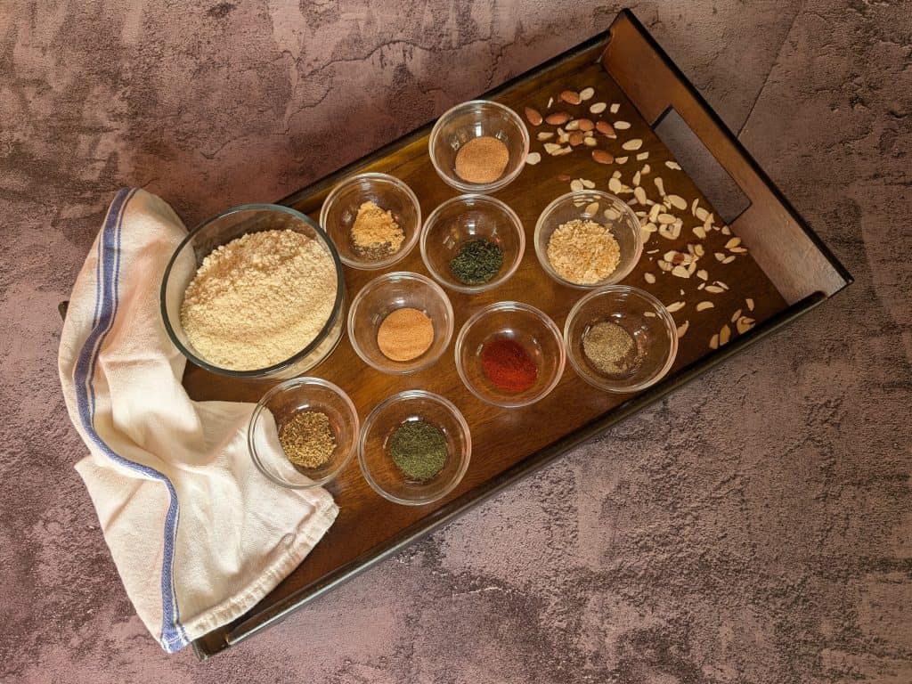 A bowl of Dinner Party Diaries Baking Mix and Spices in prep bowls on a wooden tray
