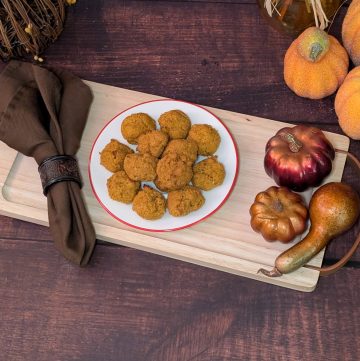 Spiced Pumpkin Muffin Balls plated next to decorative pumpkins