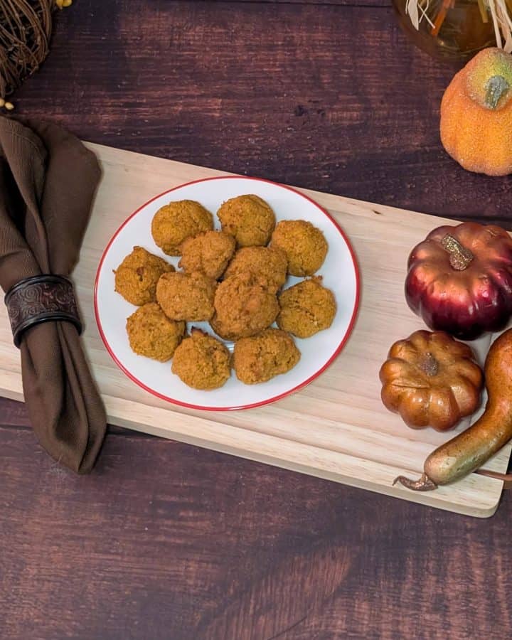 Spiced Pumpkin Muffin Balls plated next to decorative pumpkins