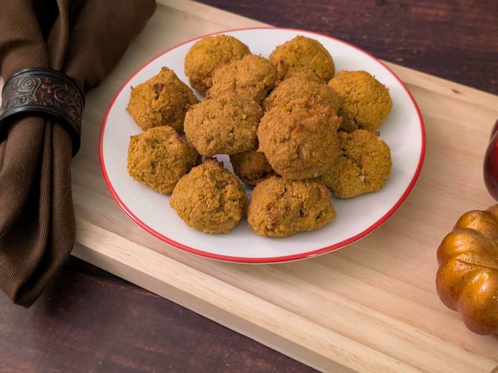 Spiced Pumpkin Muffin Balls plated next to decorative pumpkins close up